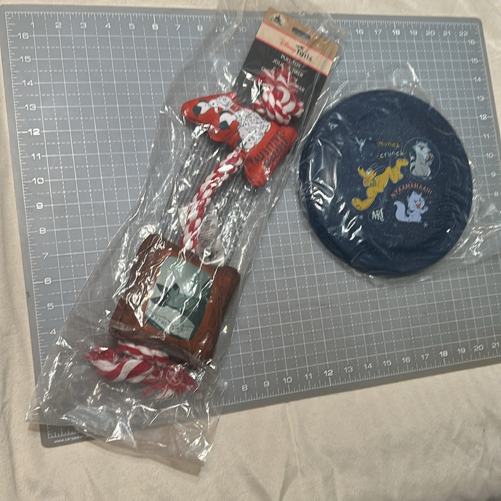 Red and White Dog Pull Toy and a disk blue new Disney tails
